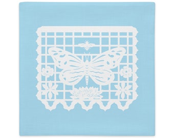 Butterfly decorative pillow sham 22"x22" in baby blue with white papel picado from the book A Is For Alpaca And Amigos © by Lisa Osterman