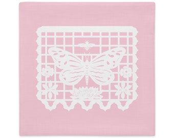 Butterfly decorative pillow sham 22"x22" in baby pink with white papel picado from the book A Is For Alpaca And Amigos © by Lisa Osterman