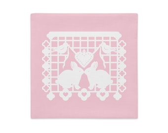 Bunny Rabbit decorative pillow sham 18"x18" in baby pink with white papel picado from the book A Is For Alpaca And Amigos © by Lisa Osterman