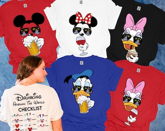 May include: Five different t-shirts featuring Disney characters Mickey Mouse, Minnie Mouse, Donald Duck, and Daisy Duck. Each character is wearing sunglasses and holding a drink. The t-shirts are in red, white, black, blue, and red colors. The back of one of the t-shirts has the text "Drinking Around the World Checklist" with a list of countries and their flags.