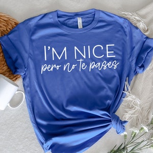 May include: A royal blue t-shirt with the text "I'm nice pero no te pases" in white.