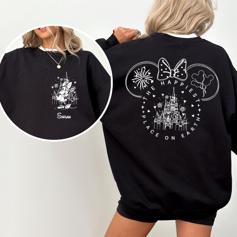 May include: Black sweatshirt with white trim featuring a Disney castle and Minnie Mouse design. The front has a castle and Minnie Mouse graphic with the name "Sarah". The back has a Mickey Mouse head outline with the text "The Happiest Place on Earth".