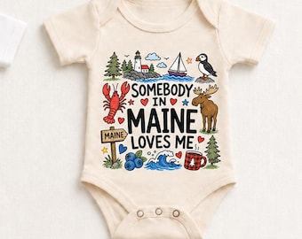 May include: Two short-sleeve baby bodysuits in white and natural colours. The graphic features a lighthouse, sailboat, puffin, lobster, moose, blueberries, waves, and a mug with the text: SOMEBODY IN MAINE LOVES ME. The text 100% COTTON is below.