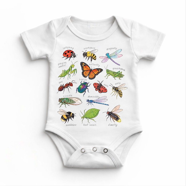 May include: White baby bodysuit with colourful illustrations of insects such as a ladybug, butterfly, and dragonfly. Each insect is labelled with its name in a playful font. The bodysuit has short sleeves and snap closures.