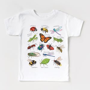 May include: White t-shirt with a colourful illustration of insects such as a ladybug, butterfly, and dragonfly. Each insect is labelled with its name in a handwritten font. The shirt is made of a soft, comfortable material.
