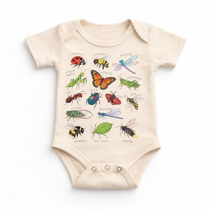 May include: A cream-coloured baby onesie with colourful illustrations of insects, such as a ladybug, butterfly, and dragonfly. Each insect's name is printed above its image. The onesie has short sleeves and popper fastenings.