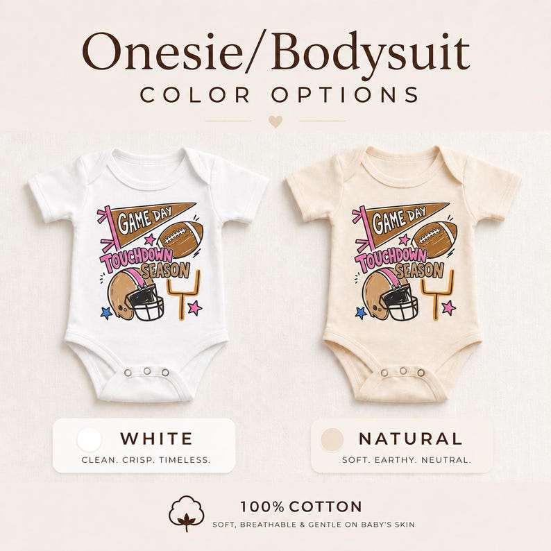 May include: Two short-sleeved bodysuits in white and natural colors, featuring a graphic print with a football, helmet, goal post, and the text 'GAME DAY TOUCHDOWN SEASON'. The design includes a pennant, stars, and pink accents. The text 'Onesie/Bodysuit COLOR OPTIONS' appears at the top, with '100% COTTON' at the bottom.