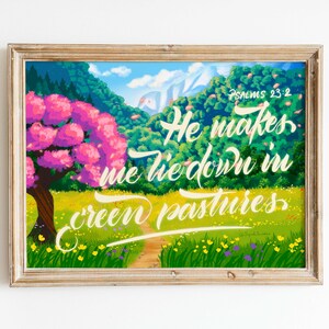 May include: A framed print with a colorful illustration of a green meadow with a path leading to a pink flowering tree. The text "Psalms 23:2 He makes me lie down in green pastures" is written in white cursive lettering.