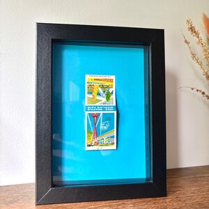 Framed 1962 Seattle World’s Fair Matchbook Art – Space Needle Illustration – Retro Mid-Century Ephemera – Blue Background – 5x7 Wall Decor