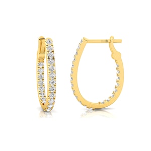 May include: A pair of gold hoop earrings with a row of small diamonds around the edge.