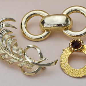 Vintage crystal brooch lot, large gold tone jewelry pins, crafting or wearable jewelry set, accent lapel brooches, accessory women