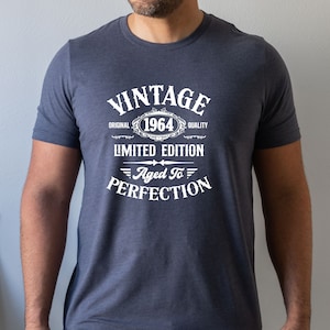 May include: A navy blue t-shirt with white text that reads "Vintage Original 1964 Quality Limited Edition Aged To Perfection".