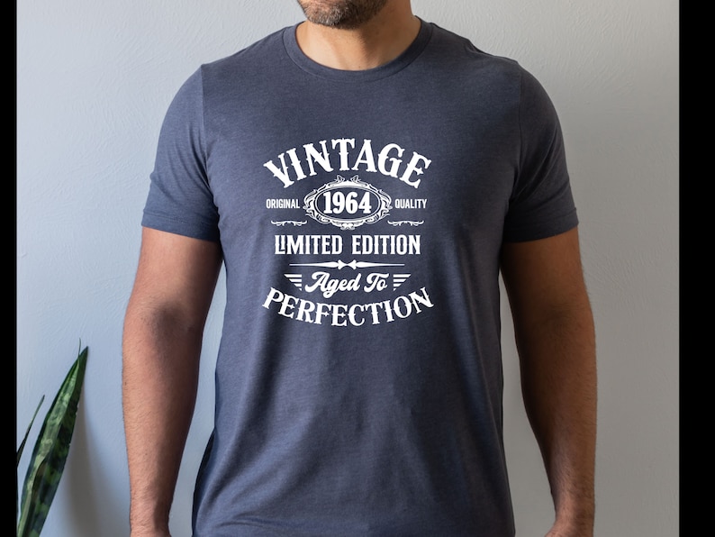 May include: A navy blue t-shirt with white text that reads "Vintage Original 1964 Quality Limited Edition Aged To Perfection".