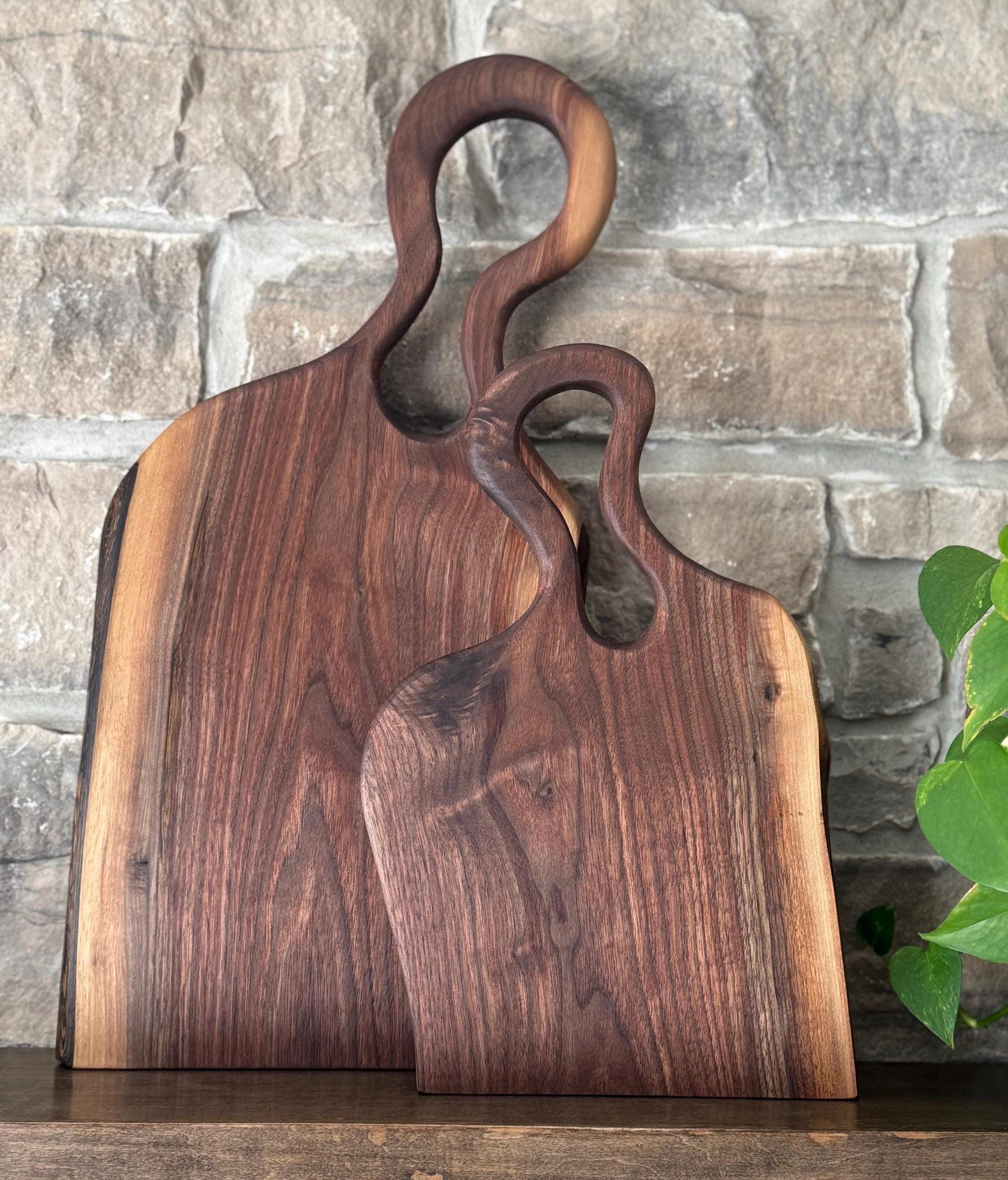 Handcrafted premium walnut charcuterie board with a hand-carved handle