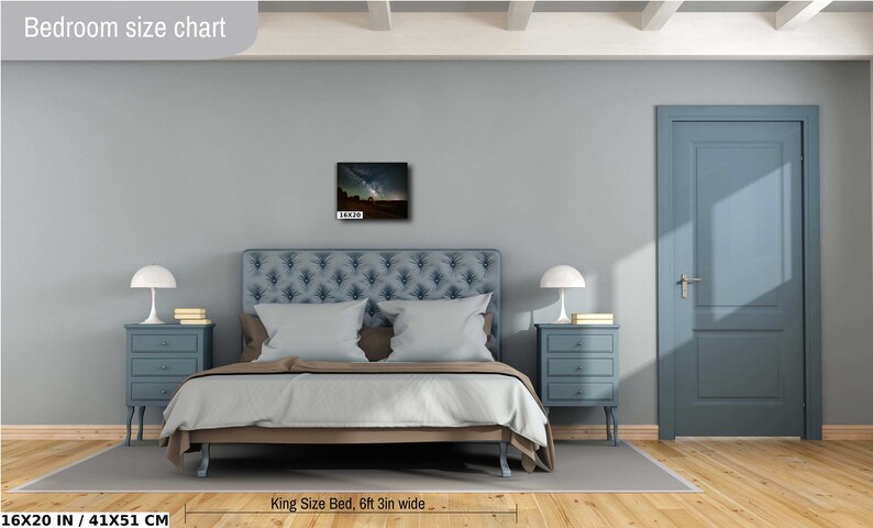 May include: A bedroom with a king-size bed, two nightstands, and a door. The bed is covered in a light blue and white patterned duvet. The nightstands are blue and have three drawers each. The door is blue and has a white door handle. The wall is light gray. The bedroom has a wooden floor. A framed picture of a starry night sky hangs on the wall above the bed. The text "Bedroom size chart" is in the top left corner of the image. The text "King Size Bed, 6ft 3in wide" is below the bed. The text "16X20 IN / 41X51 CM" is in the bottom left corner of the image.