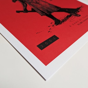 Silent Hill 2 Game Poster - Character set on a red background with a mixture of Japanese and English text in black. Available in A5, A4, A3 & A2. This close up photo shows the detail of the year the game was published.