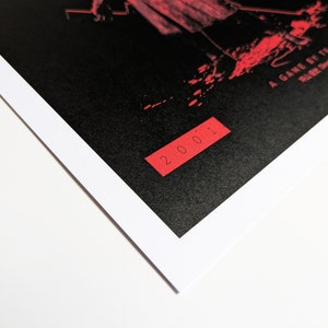 Silent Hill 2 Game Poster - Character set on a black background with a mixture of Japanese and English text in red. Available in A5, A4, A3 & A2. This close up photo shows the detail of the year the game was published.