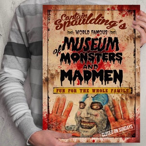 May include: A vintage-style poster advertising Captain Spaulding's World Famous Museum of Monsters and Madmen. The poster features a bloody, red background with a faded, yellowed image of a man with a clown-like face and a sinister smile. The text on the poster reads "Captain Spaulding's World Famous Museum of Monsters and Madmen" and "Fun for the Whole Family." The poster also includes the text "Closed on Sundays."