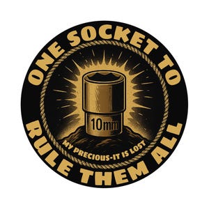 May include: A round, black sticker with a gold-colored socket wrench illustration. The text reads "ONE SOCKET TO RULE THEM ALL" and "MY PRECIOUS - IT IS LOST". The socket is labeled "10mm".