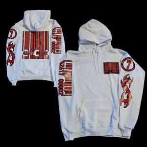 May include: White hoodie with red and black barcode designs on the sleeves and a red and black barcode design on the front. The hoodie has a red number 7 on the right sleeve and a red and black design on the left sleeve.