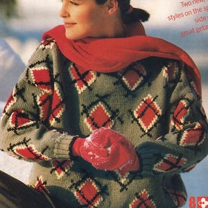 May include: A gray sweater with a red and black diamond pattern. The person is wearing a red scarf and red mittens. The image has text that says "Two new, styles on the side great getaw".