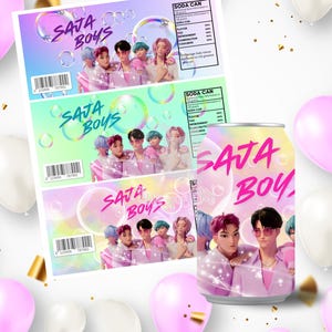 May include: A soda can and labels with the text "SAJA BOYS" in pink. The design features a group of people in pink outfits, surrounded by bubbles. The background is a gradient of pink, purple, and blue. Balloons and confetti are scattered around.