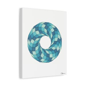 May include: A canvas print featuring a geometric design of a torus shape. The artwork is composed of a repeating pattern of blue and teal squares, creating a three-dimensional effect. The canvas is mounted on a white frame.