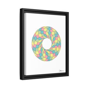 May include: A framed print of a colorful geometric design. The design is a 3D optical illusion of a ring made of squares in shades of pink, blue, and yellow.