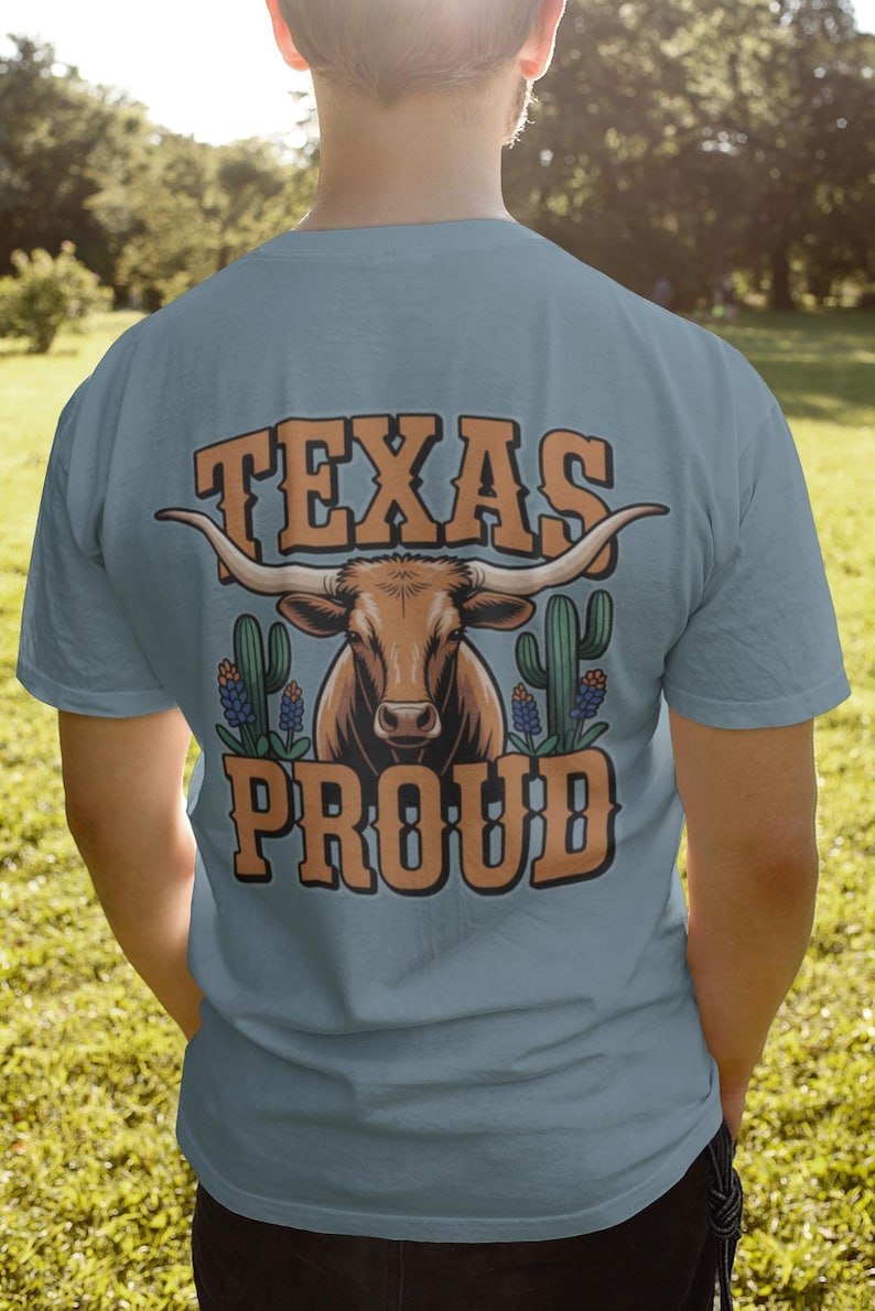 A man wearing a blue shirt that says "Texas Proud" with a longhorn and bluebonnet graphics