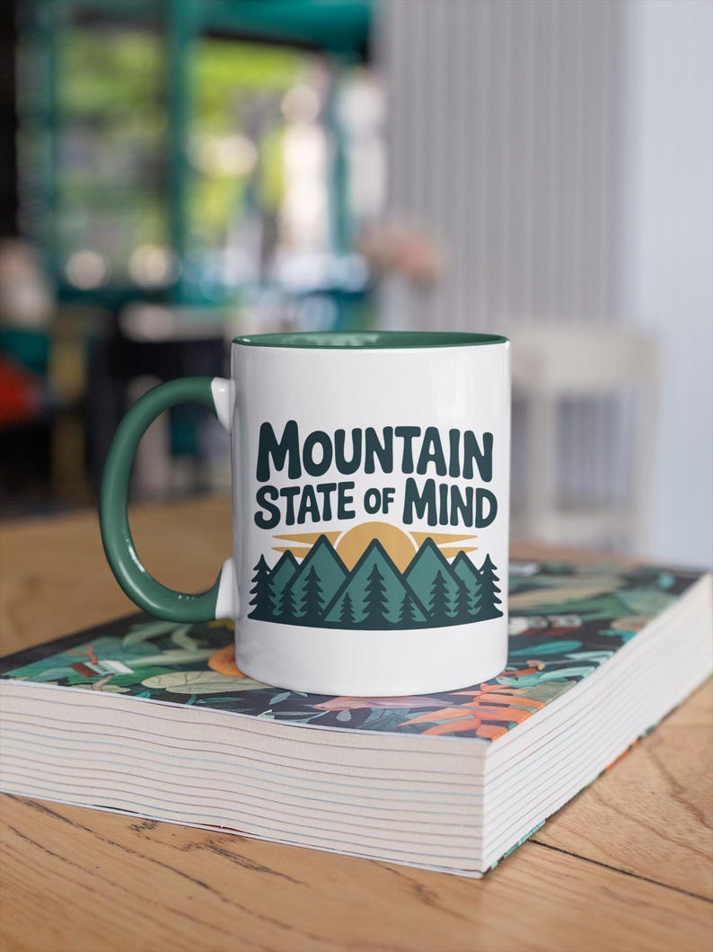 a coffee mug that says "Mountain state of mind" with a mountain graphic. this design is part of A collection of west virginia vector designs perfect for cricut, silhouette, sublimation, DTF Printing, POD, tshirts, mugs, tote bags and more!