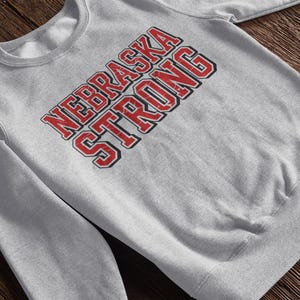 A grey sweatshirt that says "Nebraska Strong"