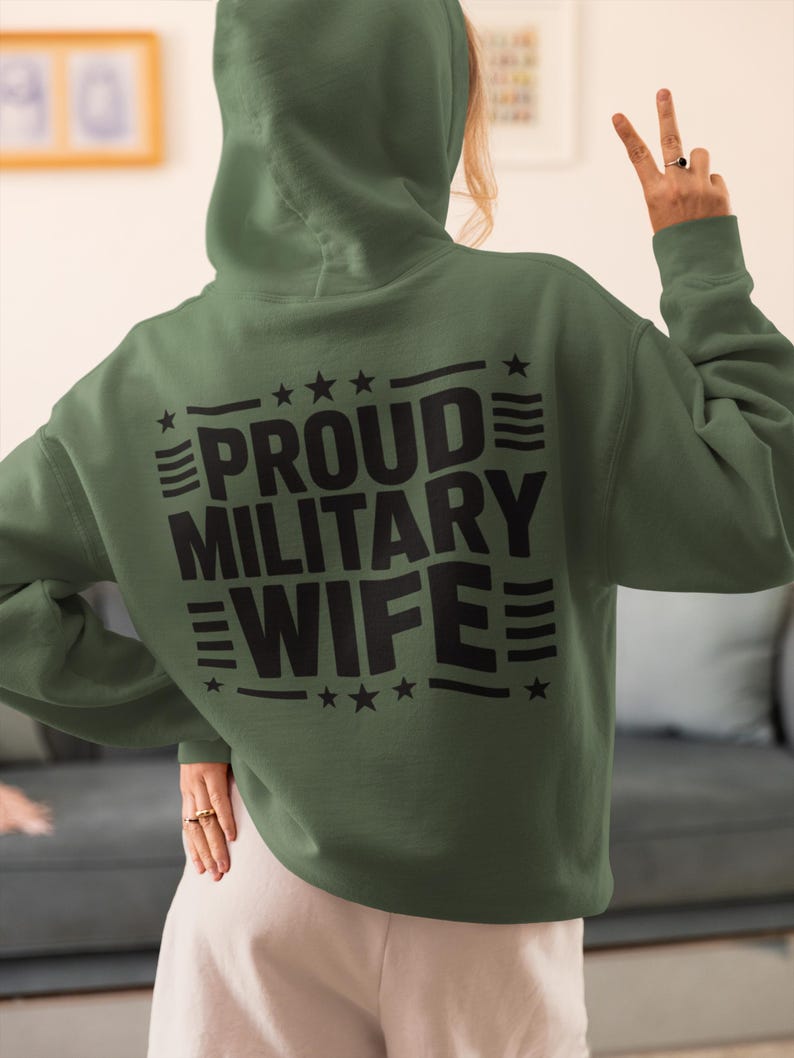 A woman in a army green sweatshirt that says proud military wife