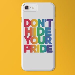 A phone case with a graphic that says "dont hide your pride" with rainbow colored font on a yellow/orange background