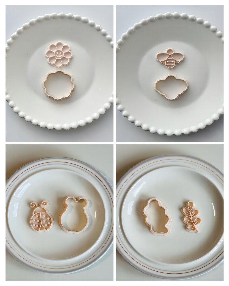 May include: Four white plates with different cookie cutters on them. The cutters are shaped like a flower, a bee, a ladybug, a cloud, a bear, and a leaf.