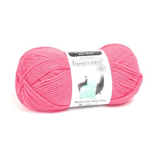 May include: A pink ball of yarn labeled "Impeccable" with 285 yards / 4.5 oz / 260 m / 127.5 g.