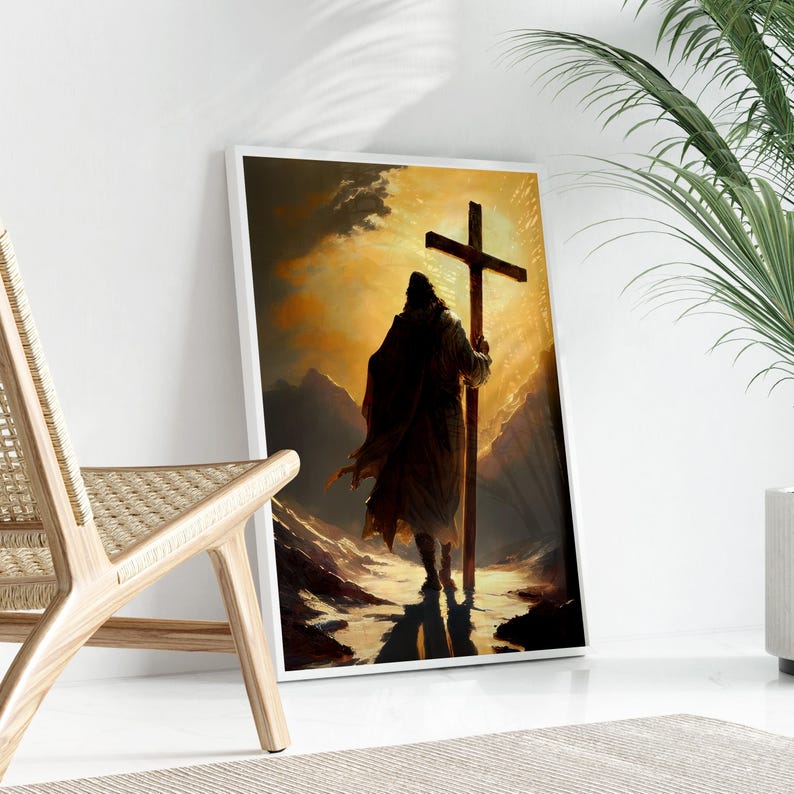 a person carrying a cross, standing in a desert-like setting with mountains in the background.