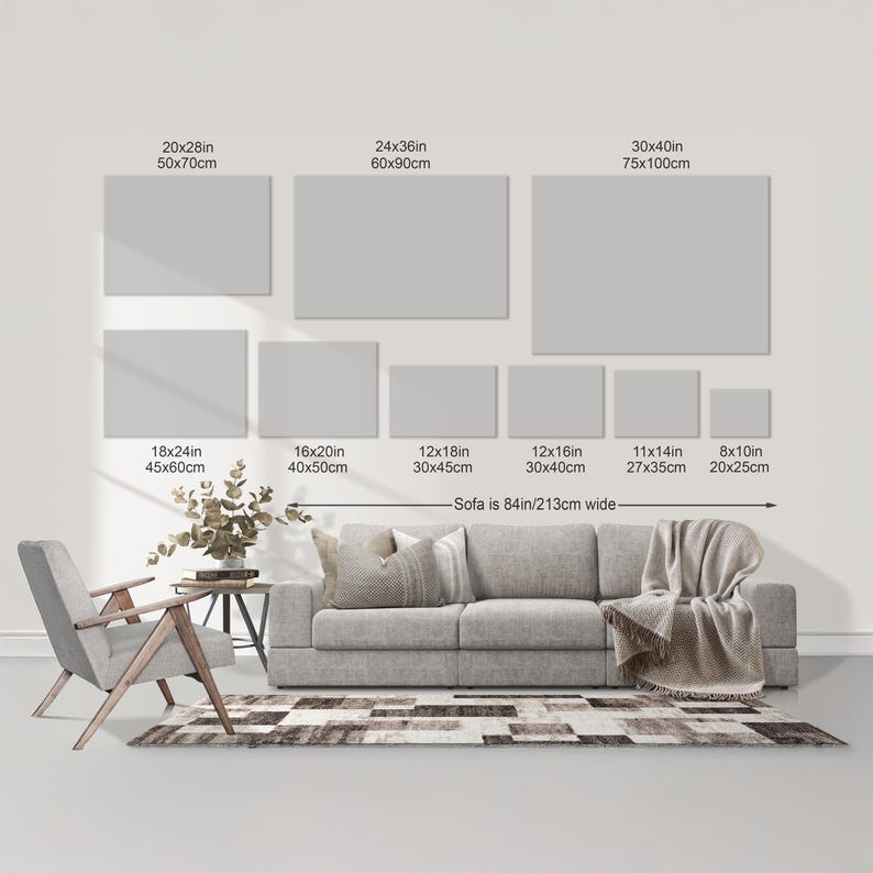 a living room with a gray sofa, a wooden chair, and a rug. There are seven different-sized gray canvas prints displayed on the wall above the sofa, ranging from 20x28in to 30x40in in size. The wall also has a scale indicating the size of the canvas prints, with the largest print being 30x40cm and the smallest being 20x28cm.