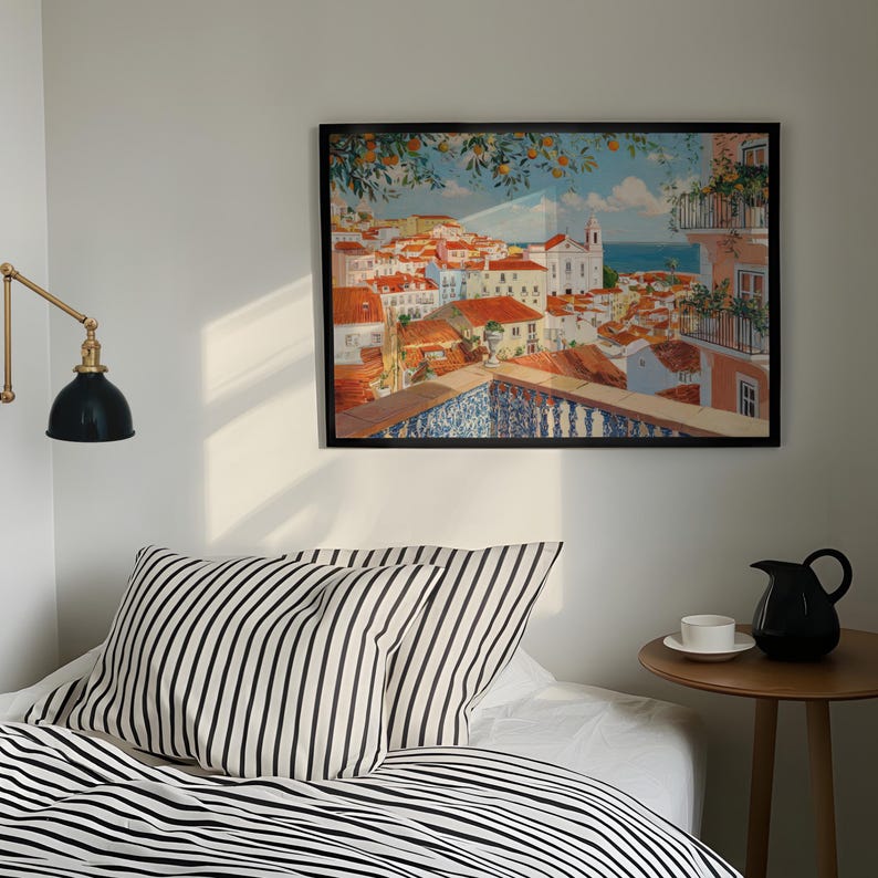 a cozy bedroom scene with a bed, a nightstand, and a framed painting of a colorful cityscape hanging on the wall above the bed.