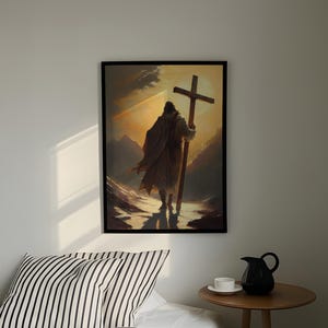 a person carrying a large cross, standing in a snowy landscape with mountains in the background.