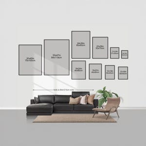 a living room with a large black sectional sofa, a chair, and a rug. Above the sofa, there are nine framed artworks of varying sizes displayed on the wall. The artworks are arranged in a grid-like pattern, with each frame having a specific size and dimensions. The wall is painted white, and the furniture and artworks create a cohesive and visually appealing interior design.