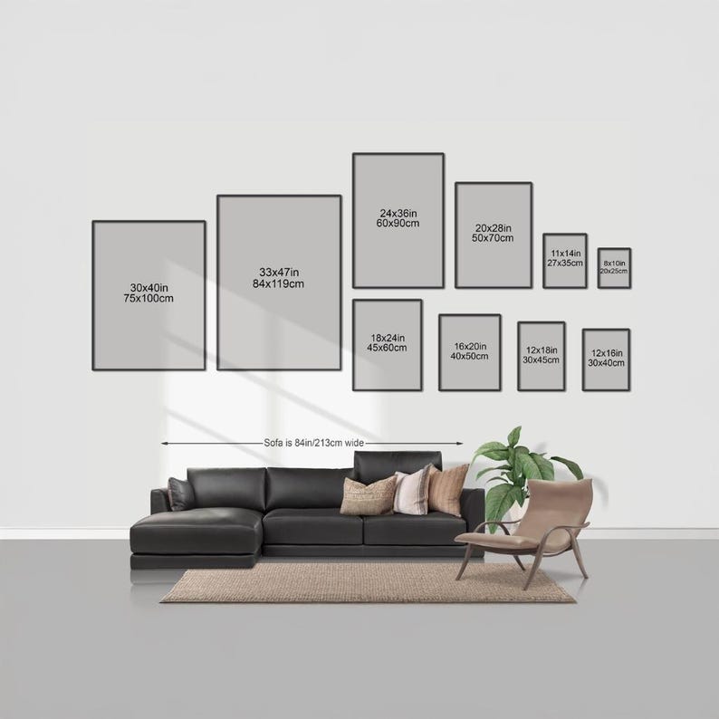 a living room with a large black sectional sofa, a chair, and a rug. Above the sofa, there are nine framed artworks of varying sizes displayed on the wall. The artworks are arranged in a grid-like pattern, with each frame having a specific size and dimensions. The wall is painted white, and the furniture and artworks create a cohesive and visually appealing interior design.