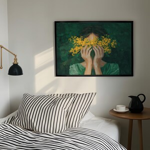a cozy bedroom scene with a bed, a nightstand, and a framed painting of a woman with yellow flowers covering her face.