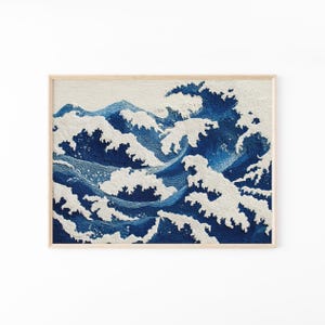 May include: A framed print featuring a stylized depiction of ocean waves. The artwork showcases dynamic blue waves with white crests, set against a light background. The waves are rendered with textured details, creating a sense of movement and depth. The frame is a light wood color.