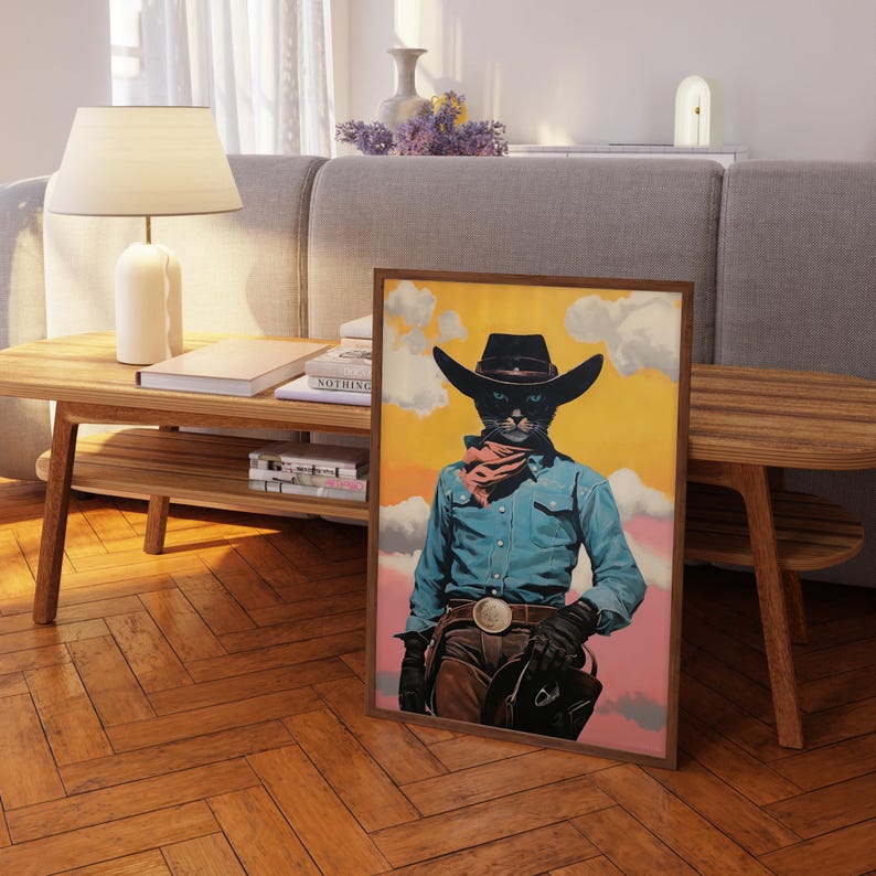 a framed picture of a cat dressed as a cowboy, standing on a wooden floor in a living room setting.
