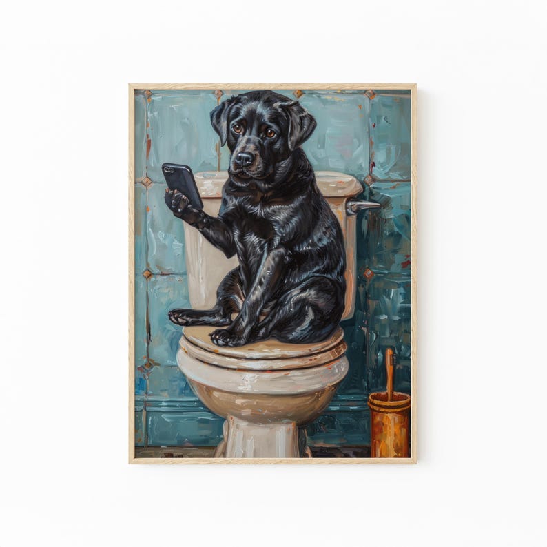 A black dog sitting on a toilet and holding a cell phone.