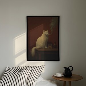 a white cat sitting on a table, with a glass of wine and a black pitcher nearby.