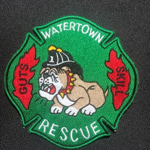 May include: Green and red embroidered patch with a bulldog wearing a firefighter's helmet. The patch says "Watertown Rescue" with "Guts" and "Skill" on either side of the bulldog.
