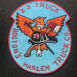 May include: An embroidered patch in blue and red with a phoenix design and the text "Boston's Harlem Truck Co. 23 Truck".