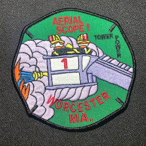 May include: Green and purple embroidered patch with the text "Aerial Scope 1" and "Worcester MA."  The patch features a cartoon image of a fire truck ladder with two firefighters.