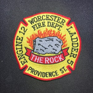 May include: A yellow and red circular patch with the text "Worcester Fire Dept. Engine 12 Ladder 51 The Rock Providence St."